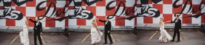 bride and groom dancing in front of detroit mural