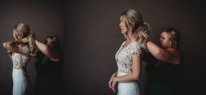 bride getting her necklace put on by bridesmaid