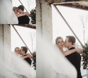 bride and groom kissing with veil blowing in the wind belle isle boathouse wedding