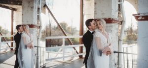 bride and groom hugging and kissing in winter belle isle boathouse