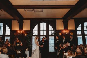 bride and groom holding hands and exchanging vows belle Isla boathouse