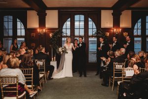 bride and groom cheering after wedding ceremony belle isle boathouse
