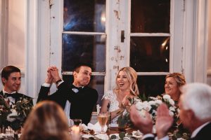 bride and groom laughing during wedding reception toasts belle isle boat house