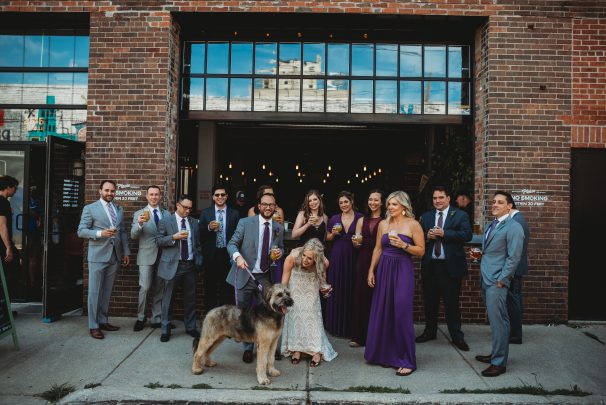 wedding party drinking beer in front of eastern market brewing company with dog
