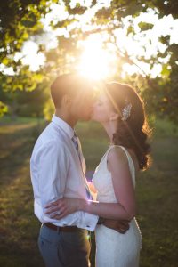 bride and groom kissing at sunset at matthaei botanical garden ann arbor mi