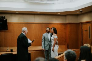 bride and groom exchanging vows in courtroom wedding ceremony