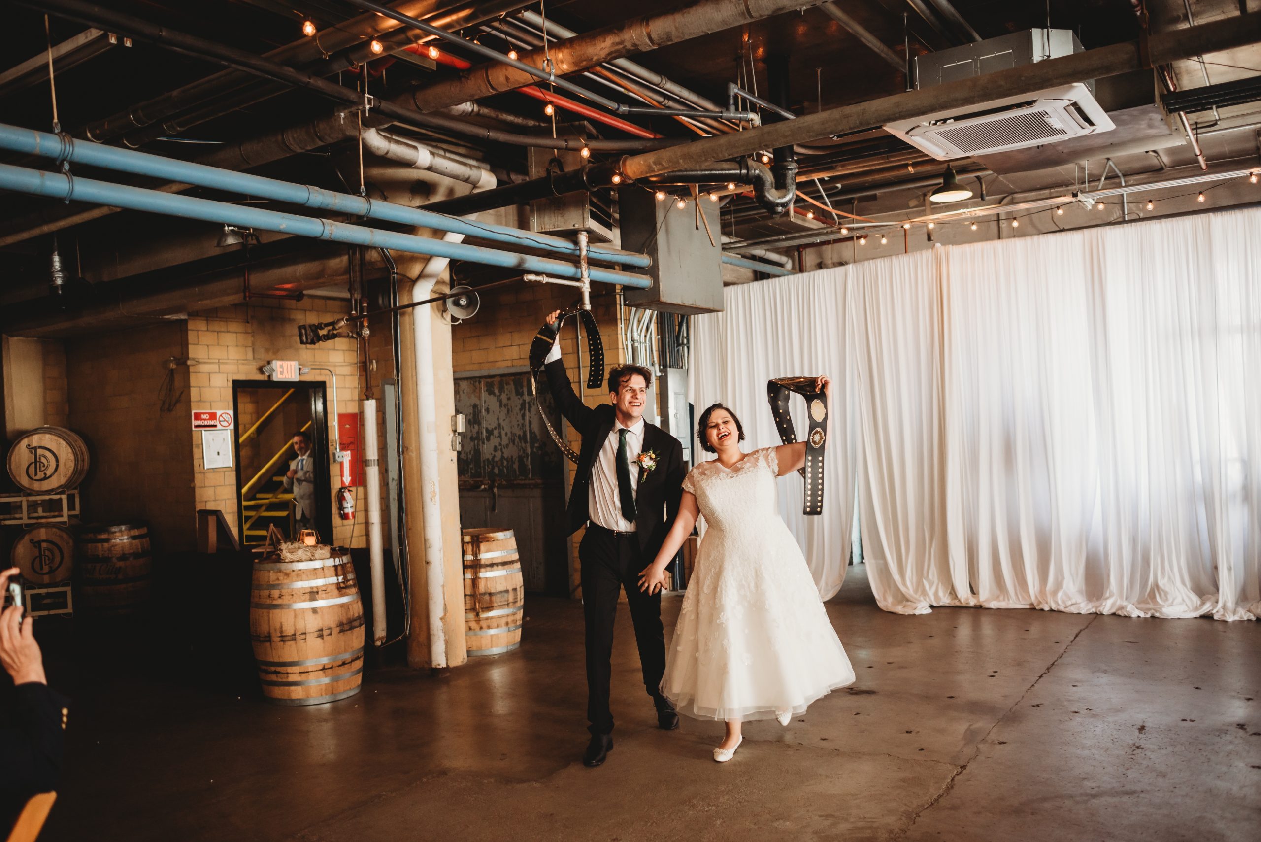 bride and groom reception entrance with WWE belts the whiskey factory detroit