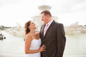 wedding couple smiling and laughing by belle isle fountain