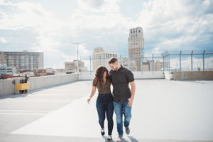 couple walking and laughing on top of parking garage in downtown detroit