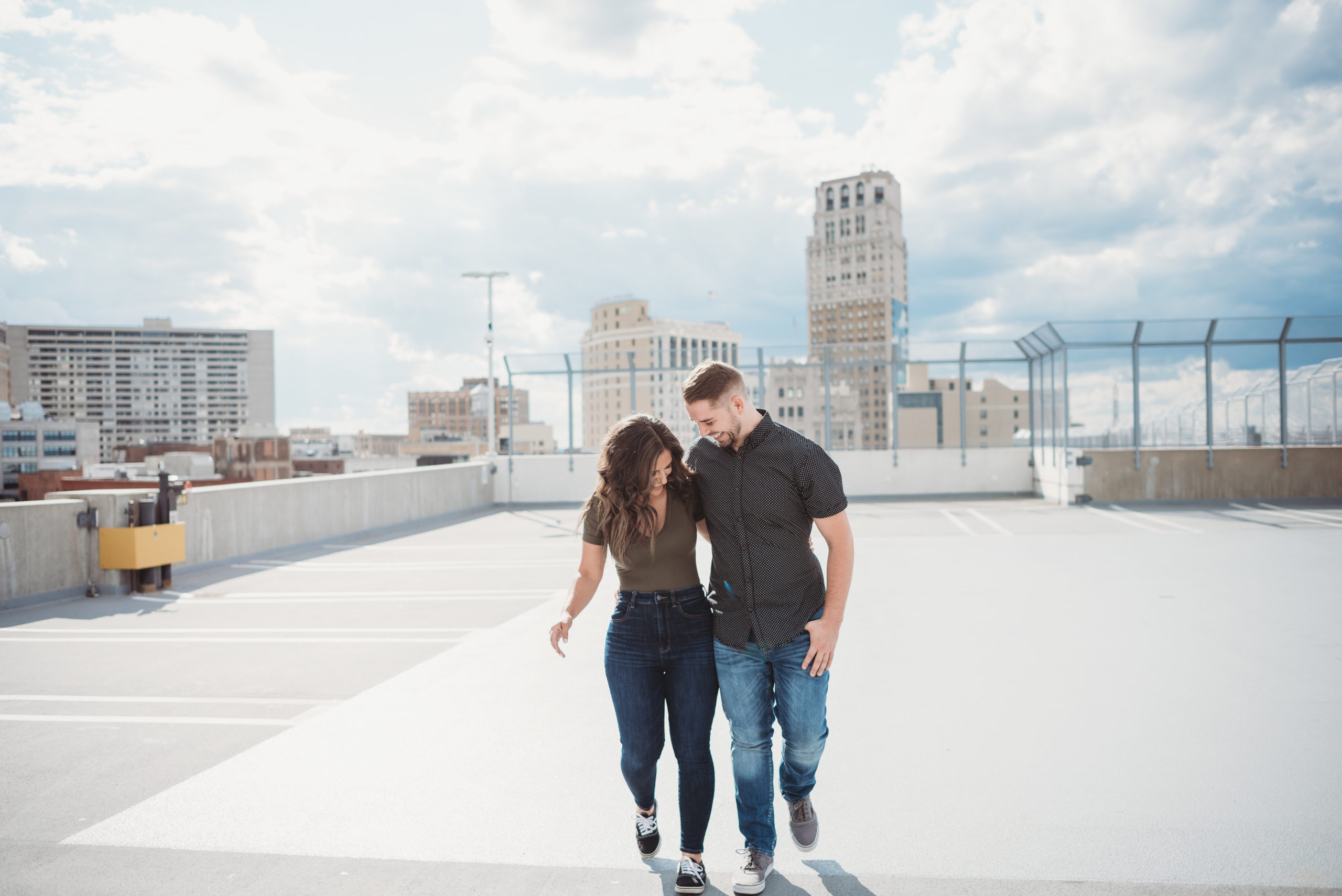 couple walking and laughing on top of parking garage in downtown detroit