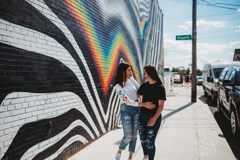 two girls laughing and kissing in eastern market Detroit 