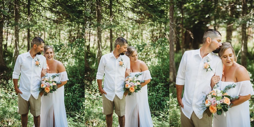 bride and groom laughing and smiling in the woods in northern michigan