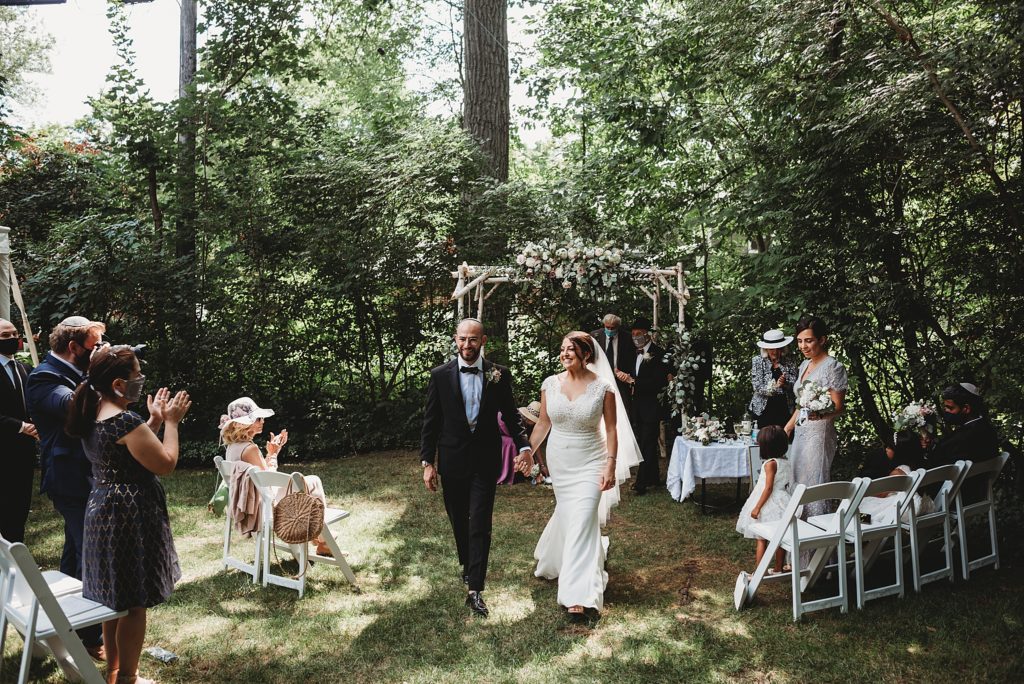jewish orthodox wedding in a backyard bride and groom walking up the aisle