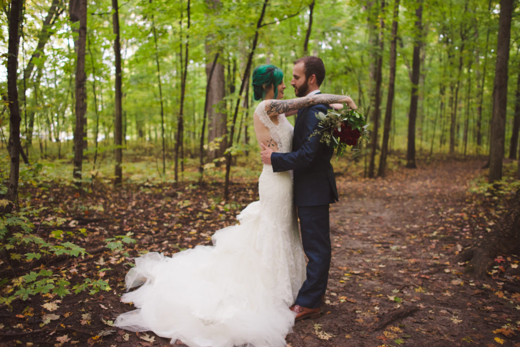 bride and groom in the woods getting married bride with green hair