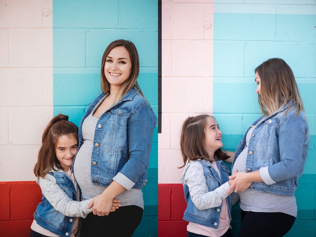 pregnant mom and daughter smiling at each other 
little girl hugging moms belly