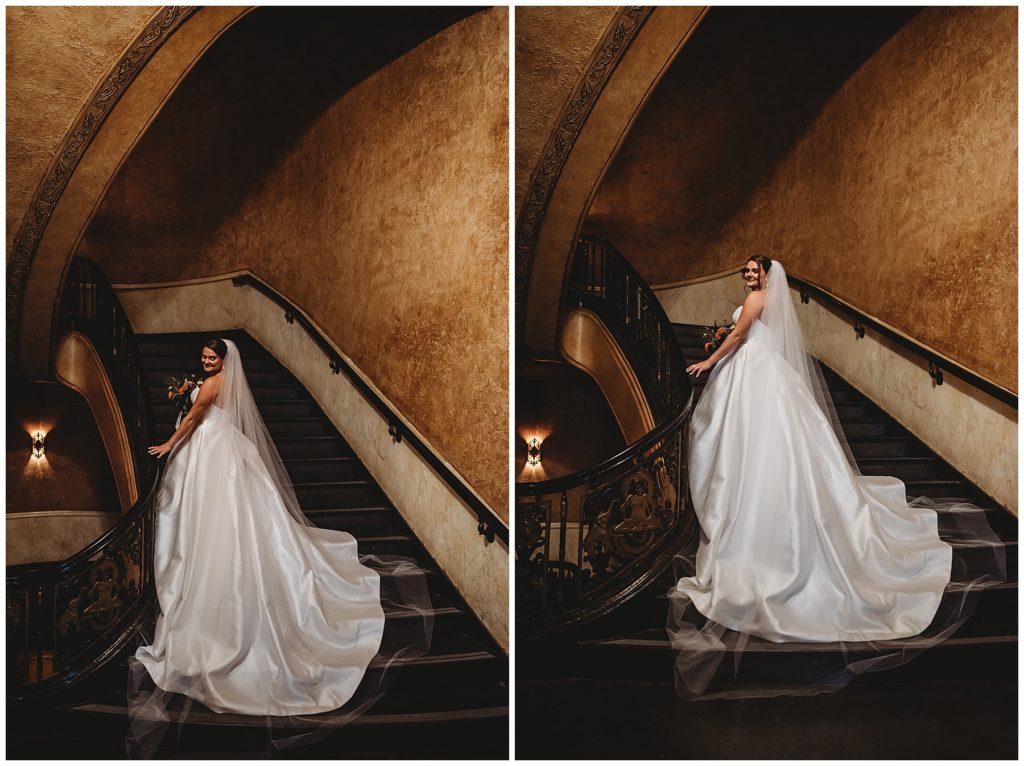 bride standing on a grand stair case for her bridal portraits on her wedding day at the historic fox theatre in Detroit Michigan. taken by one of the top wedding photographers in Detroit 